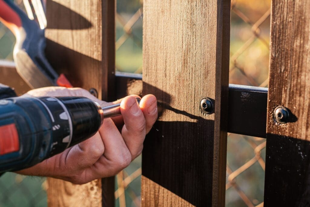 A technician is doing fence repair