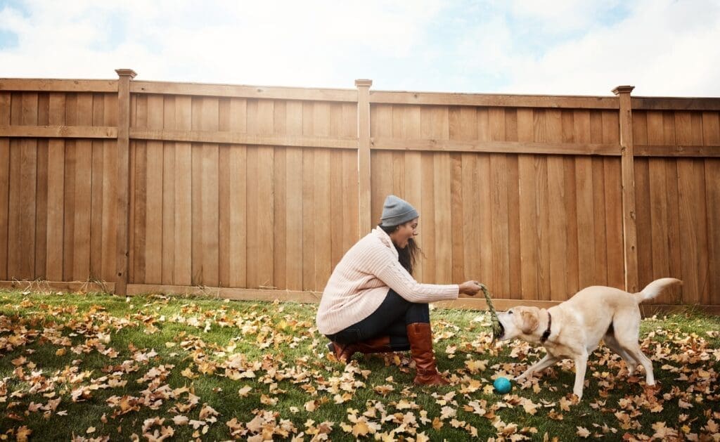 Wood Privacy Fence behind Indiana homeowner with dog